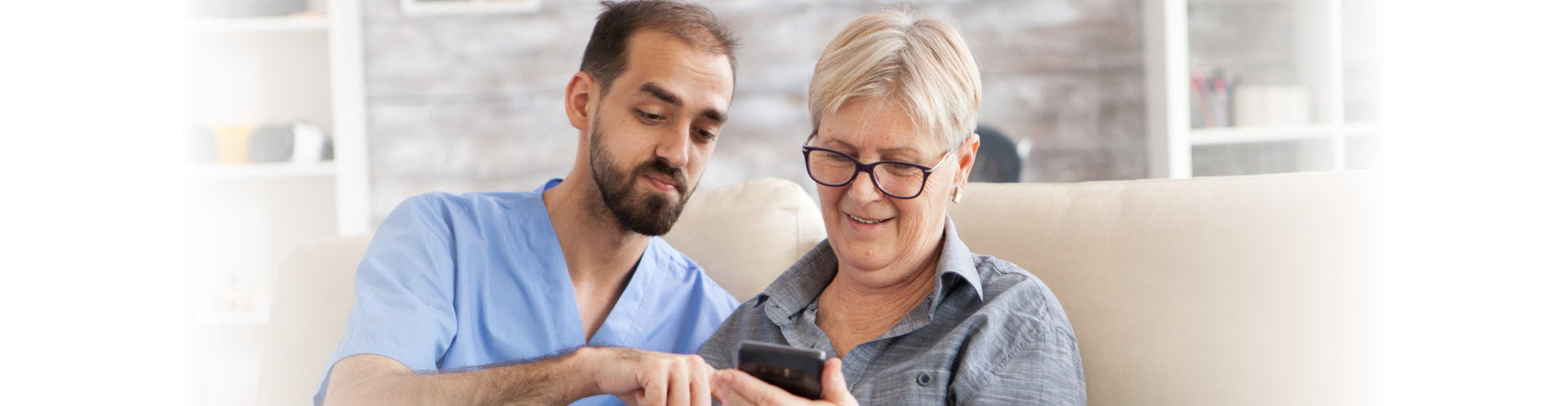 nurse assist her patient with her cellphone